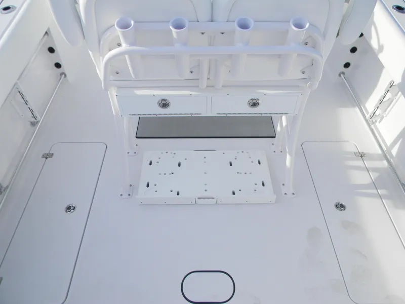 Slide: The Image of 2026 Sportsman Open 252 Center Console boat interior with rod holders and storage compartments. - 4