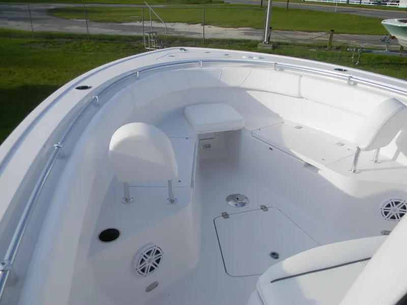 Slide: The Image of 2026 Sportsman Open 252 Center Console boat interior with white seating and storage compartments. - 8