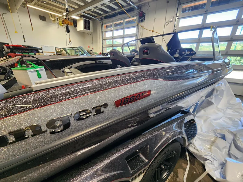 Slide: The Image of 2025 Ranger 1880MS boat in garage, metallic finish, interior view, modern design. - 2
