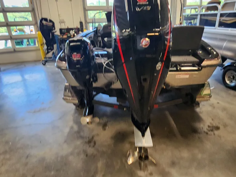 Slide: The Image of 2025 Ranger 1880MS boat with dual Mercury outboard motors in a garage setting. - 4