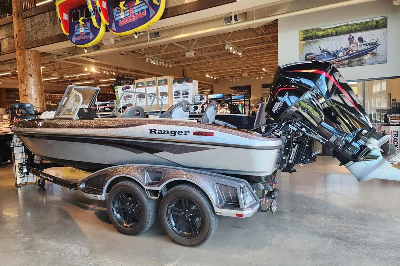 Slide: The Image of 2025 Ranger 1880MS boat displayed in a showroom with modern design and powerful engine. - 1