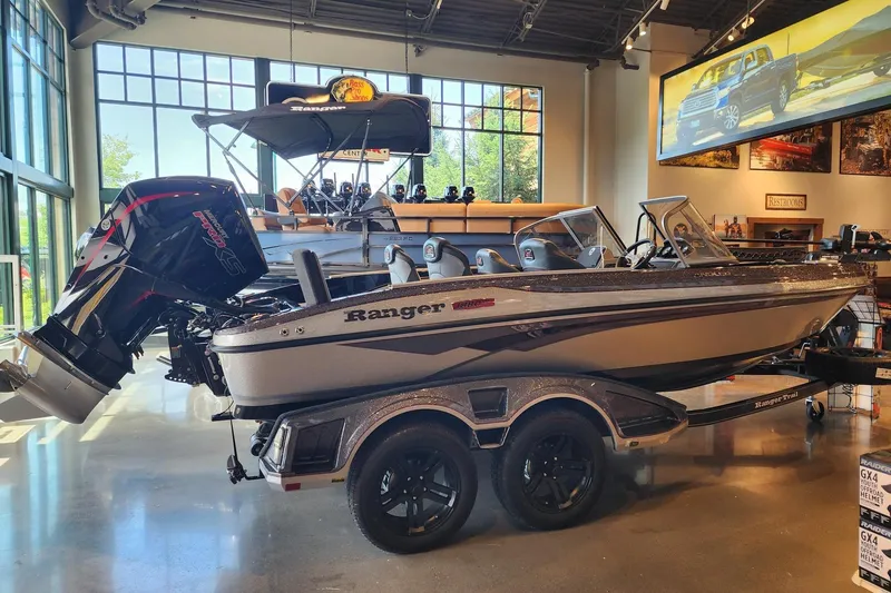 The Image of 2025 Ranger 1880MS boat displayed indoors with powerful outboard motor. - 0