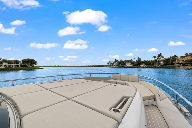 Slide: The Image of Azimut Verve 47 yacht, 2022 model, cruising on a serene waterway under a clear blue sky. - 10