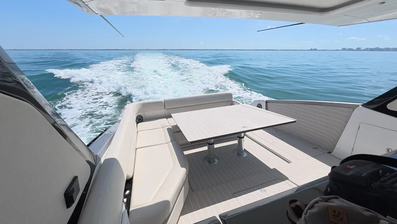 Slide: The Image of 2022 Azimut Verve 47 yacht cruising on open water, featuring a sleek deck and seating area. - 15