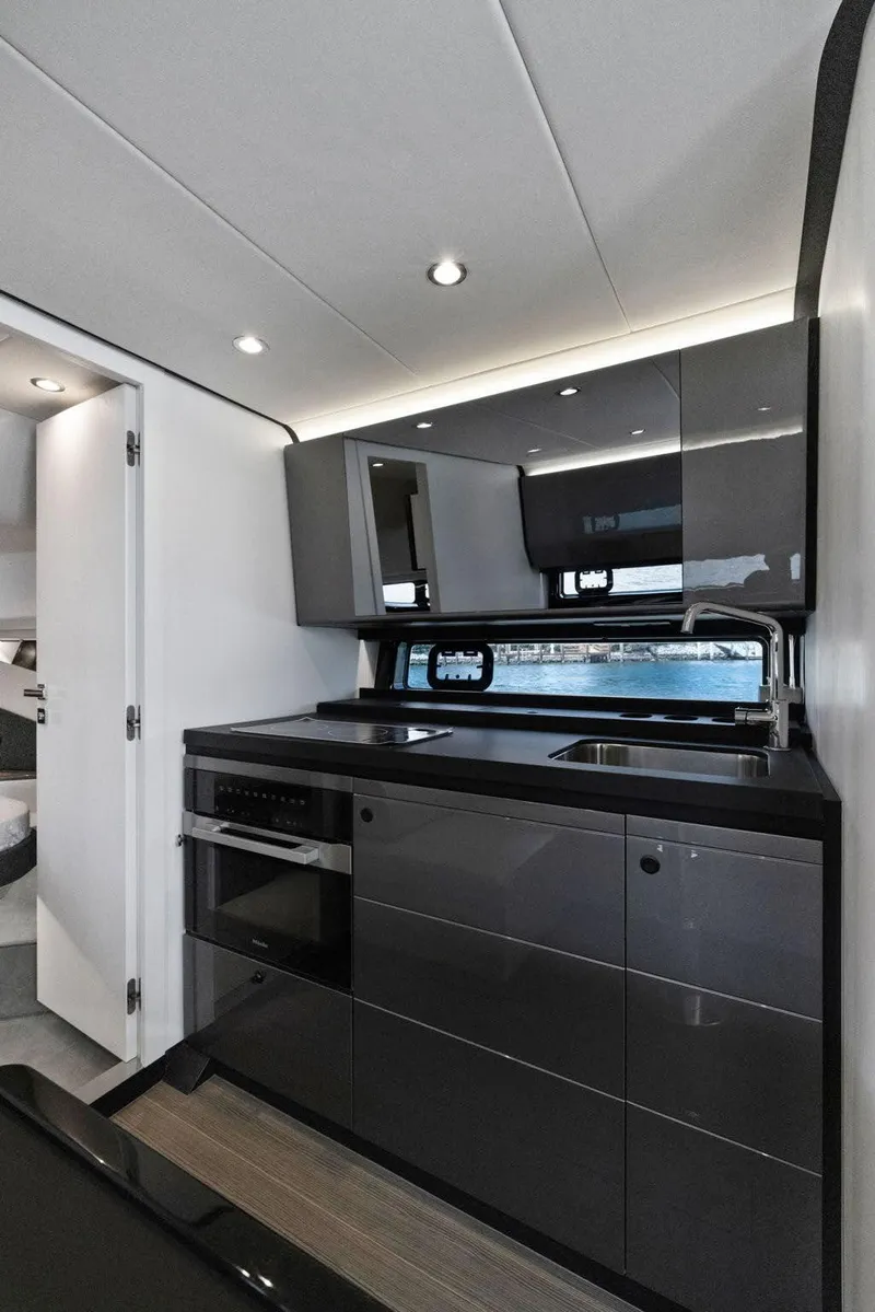 Slide: The Image of Modern kitchen interior of 2022 Azimut Verve 47 yacht, featuring sleek cabinetry and appliances. - 24