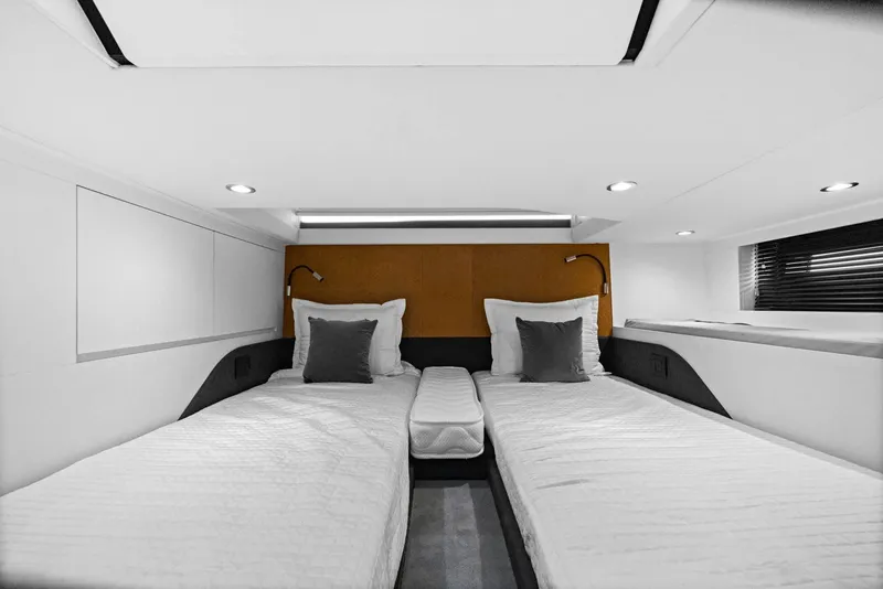 Slide: The Image of 2022 Azimut Verve 47 cabin interior with twin beds and modern lighting. - 4