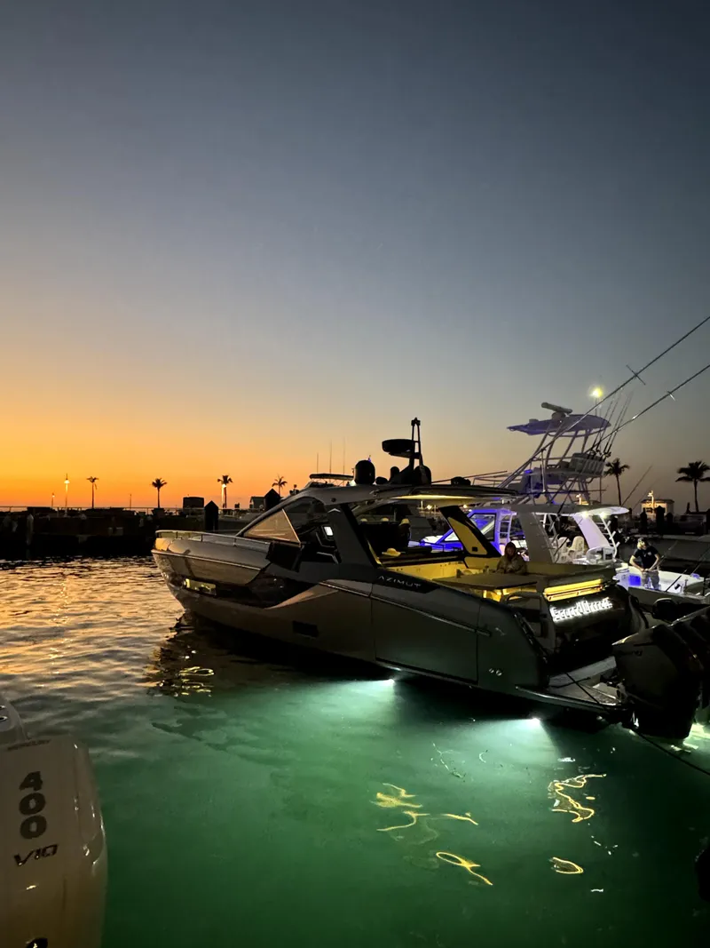 Slide: The Image of 2022 Azimut Verve 47 yacht illuminated at sunset in a marina. - 7