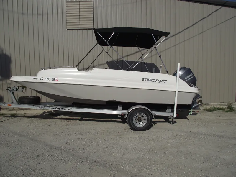Slide: The Image of 2015 Starcraft Limited 2000 OB Fish boat on trailer, parked outdoors. - 0
