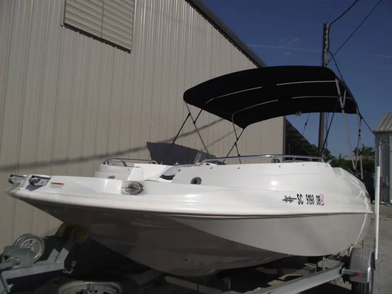 Slide: The Image of 2015 Starcraft Limited 2000 OB Fish boat with canopy, parked on trailer. - 1