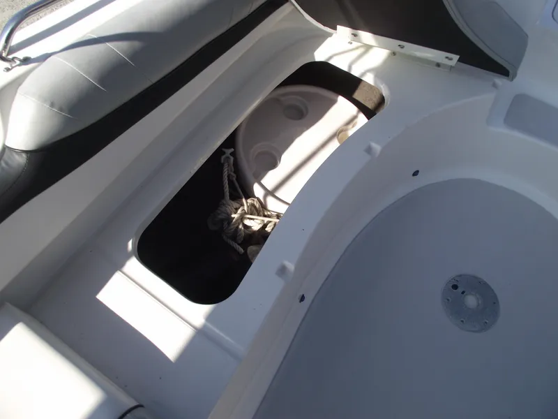 Slide: The Image of Interior view of a 2015 Starcraft Limited 2000 OB Fish boat, showing storage compartment. - 11