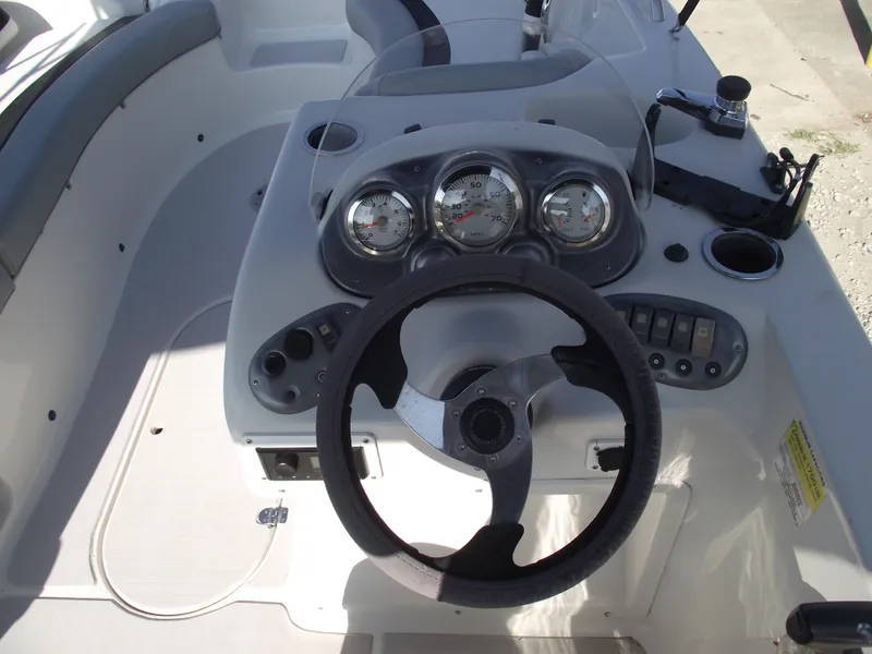 Slide: The Image of Steering console of 2015 Starcraft Limited 2000 OB Fish boat with gauges and controls. - 15