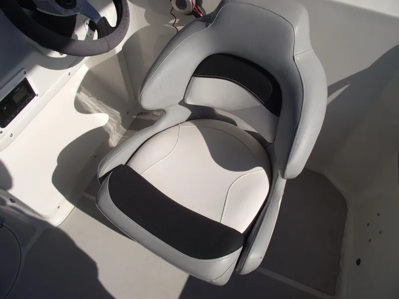 Slide: The Image of Captain's seat in 2015 Starcraft Limited 2000 OB Fish boat, featuring gray and black upholstery. - 17