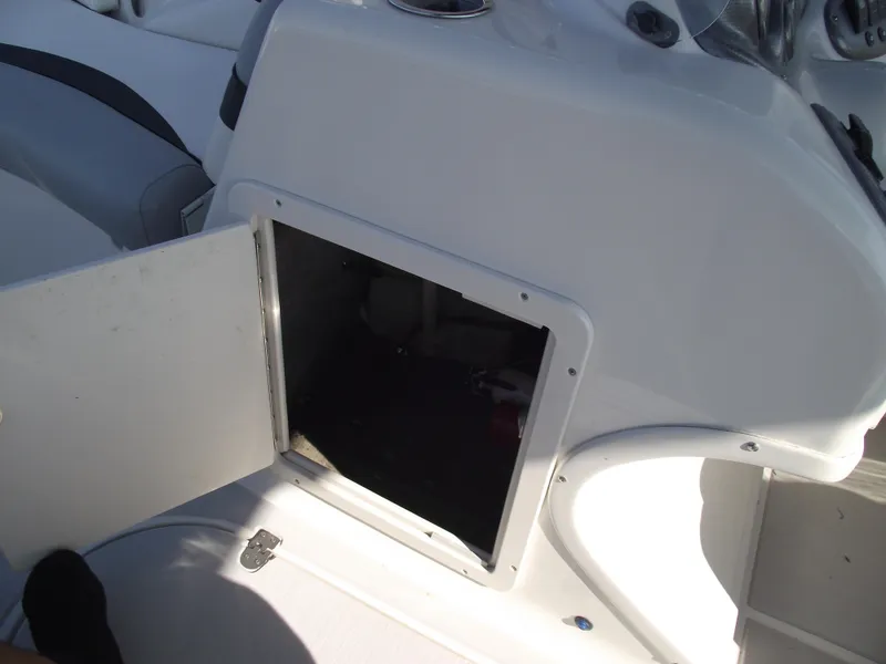 Slide: The Image of Open storage compartment on a 2015 Starcraft Limited 2000 OB Fish boat. - 23