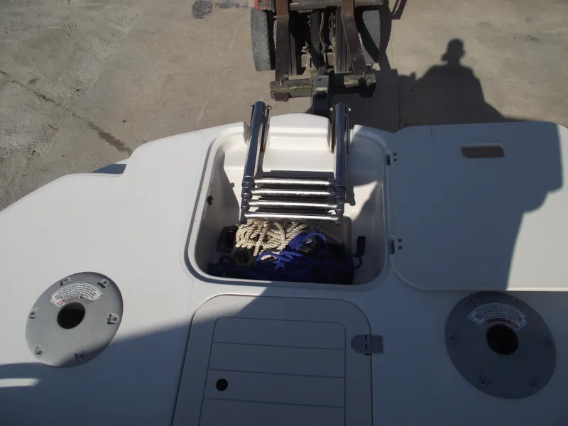 Slide: The Image of 2015 Starcraft Limited 2000 OB Fish boat with open storage compartment and ladder. - 8