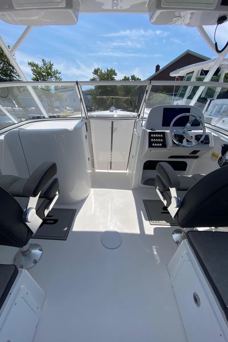 Slide: The Image of 2024 Sea Pro 240 Dual Console boat interior with modern helm and seating. - 10
