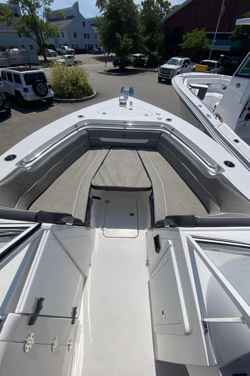 Slide: The Image of 2024 Sea Pro 240 Dual Console boat with spacious seating and sleek design in a marina setting. - 14