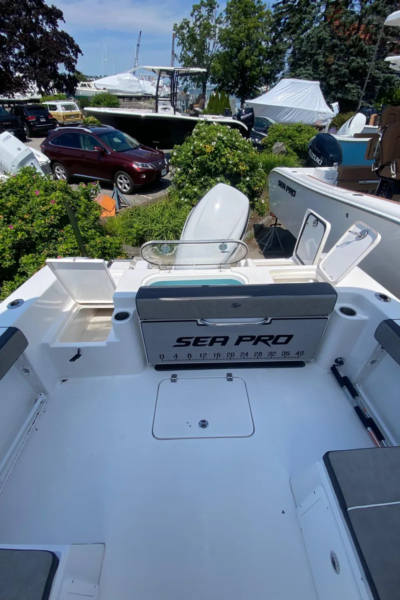 Slide: The Image of 2024 Sea Pro 240 Dual Console boat interior with seating and storage compartments. - 6