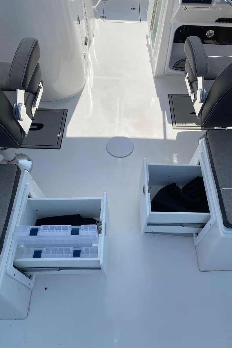 Slide: The Image of 2024 Sea Pro 240 Dual Console interior with open storage compartments and seating. - 8
