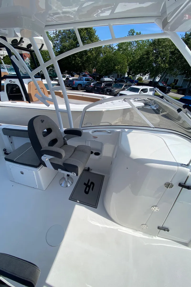 Slide: The Image of 2024 Sea Pro 240 Dual Console boat interior with captain's chair and sleek white design. - 9