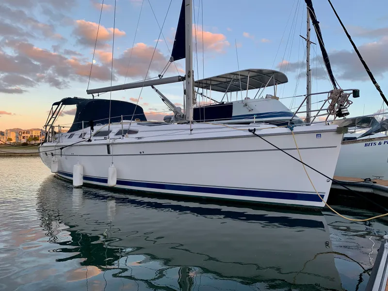 The Image of Sailboat Hunter 41 AC 2005 docked at sunset with calm water reflections. - 0