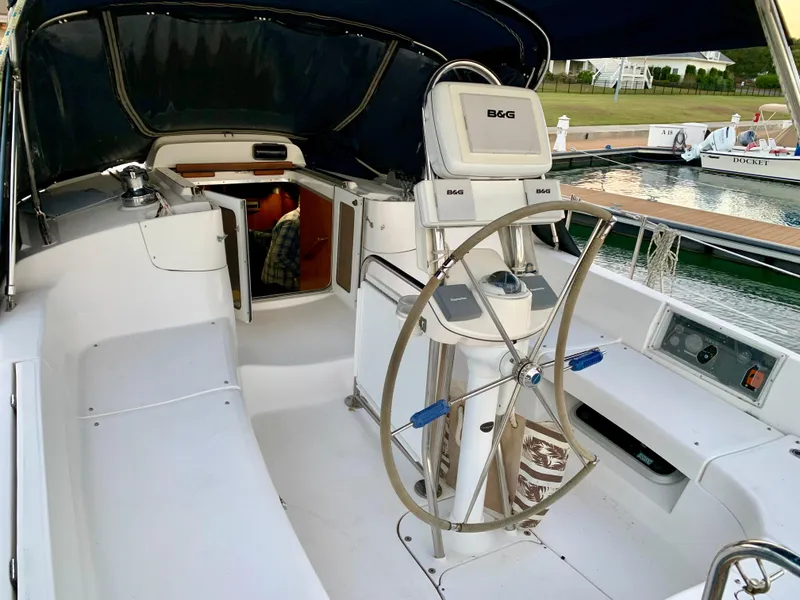 Slide: The Image of Cockpit of 2005 Hunter 41 AC sailboat with steering wheel and navigation equipment. - 10