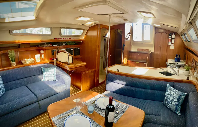 Slide: The Image of Interior of 2005 Hunter 41 AC yacht with cozy seating and dining area. - 14