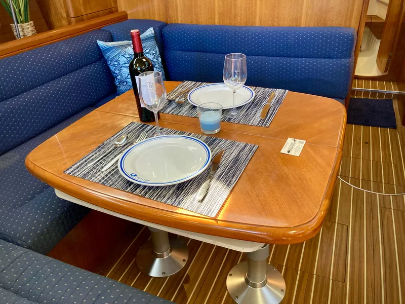 Slide: The Image of Elegant dining setup in 2005 Hunter 41 AC yacht interior with wine and tableware. - 15