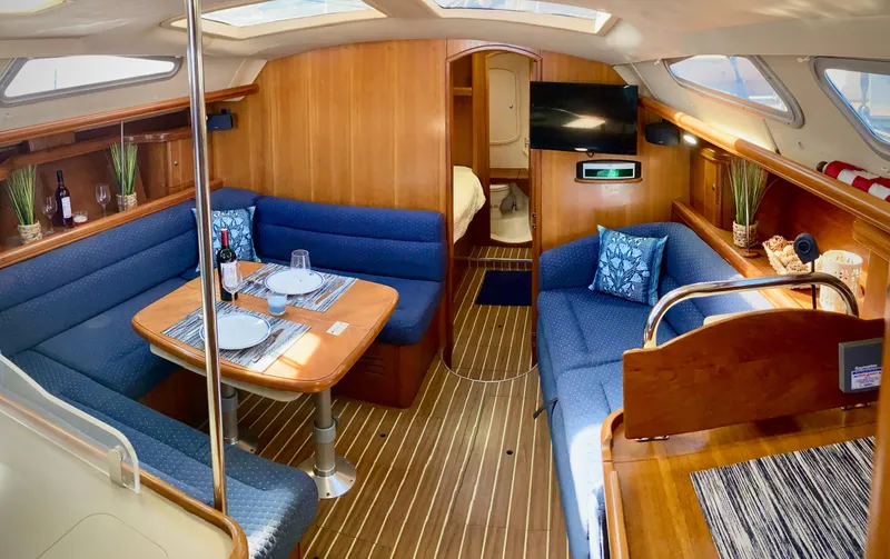 Slide: The Image of Interior of 2005 Hunter 41 AC yacht with cozy seating and dining area. - 16