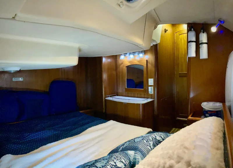 Slide: The Image of Cozy cabin interior of 2005 Hunter 41 AC sailboat with wood paneling and blue bedding. - 20