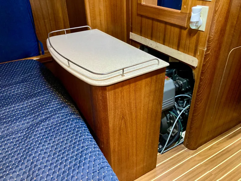 Slide: The Image of Interior of 2005 Hunter 41 AC sailboat showing engine access and wooden cabinetry. - 21