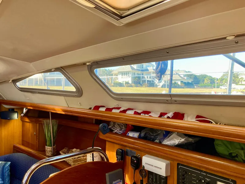 Slide: The Image of Interior of 2005 Hunter 41 AC sailboat with windows and wooden cabinetry. - 25