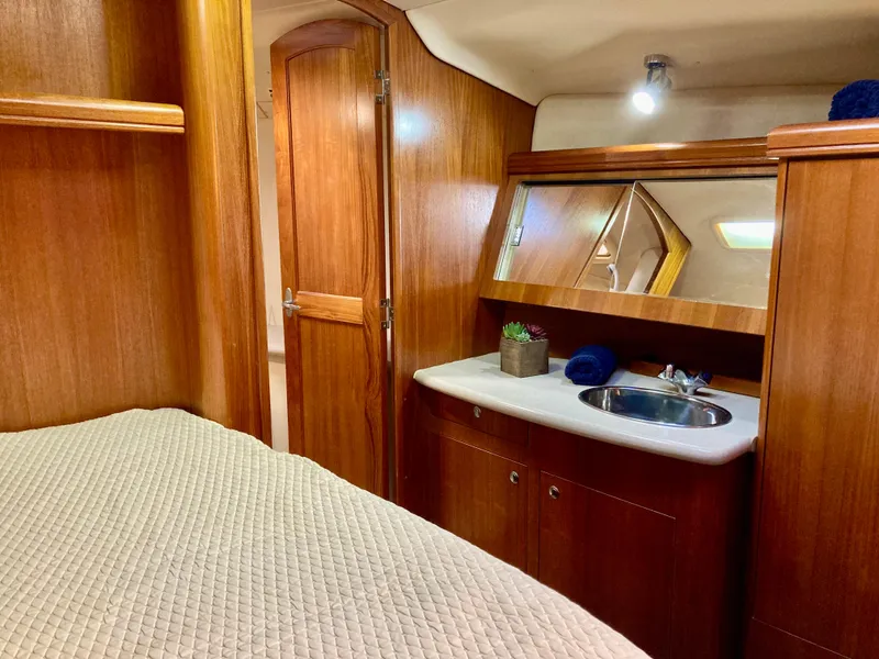 Slide: The Image of Interior of 2005 Hunter 41 AC yacht with wooden cabinetry and compact sink area. - 37