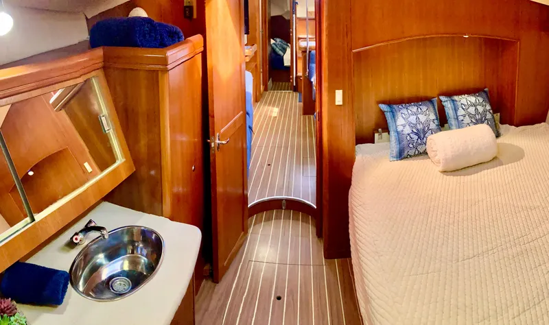 Slide: The Image of Luxurious interior of 2005 Hunter 41 AC yacht with cozy bedroom and elegant wood finish. - 39