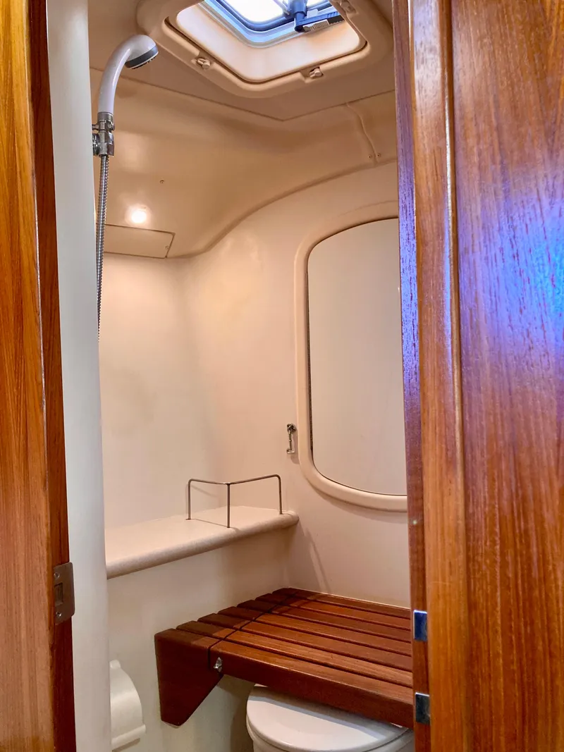 Slide: The Image of 2005 Hunter 41 AC yacht bathroom with wooden accents and skylight. - 43