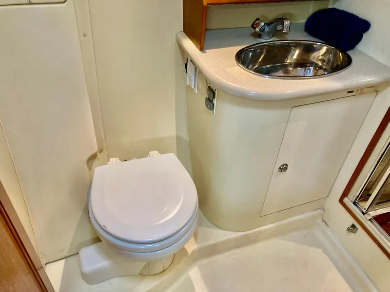 Slide: The Image of 2005 Hunter 41 AC yacht bathroom with toilet and stainless steel sink. - 45