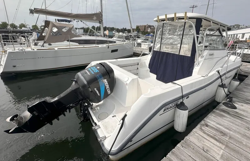 Slide: The Image of 2003 Boston Whaler 255 Conquest boat docked with Mercury outboard engine. - 2
