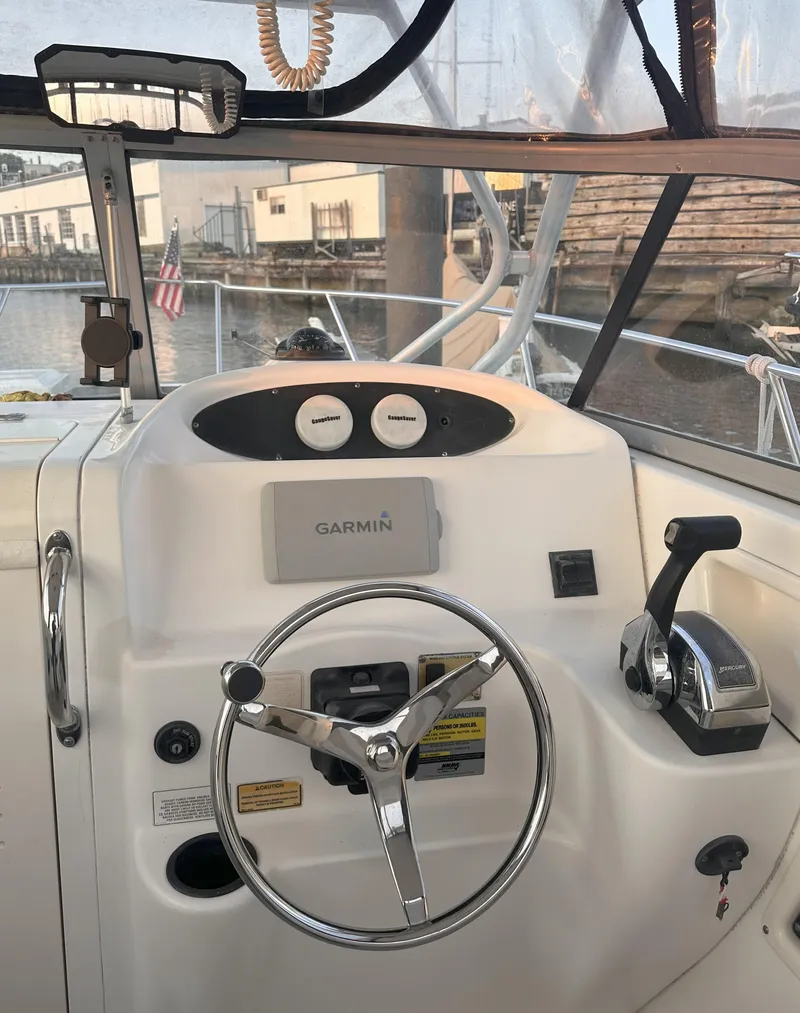 Slide: The Image of 2003 Boston Whaler 255 Conquest helm with Garmin navigation system and steering wheel. - 5