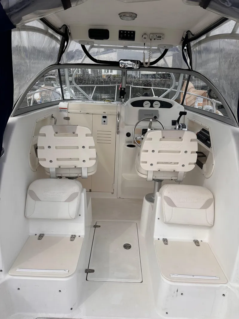 Slide: The Image of 2003 Boston Whaler 255 Conquest boat interior with helm and seating. - 6