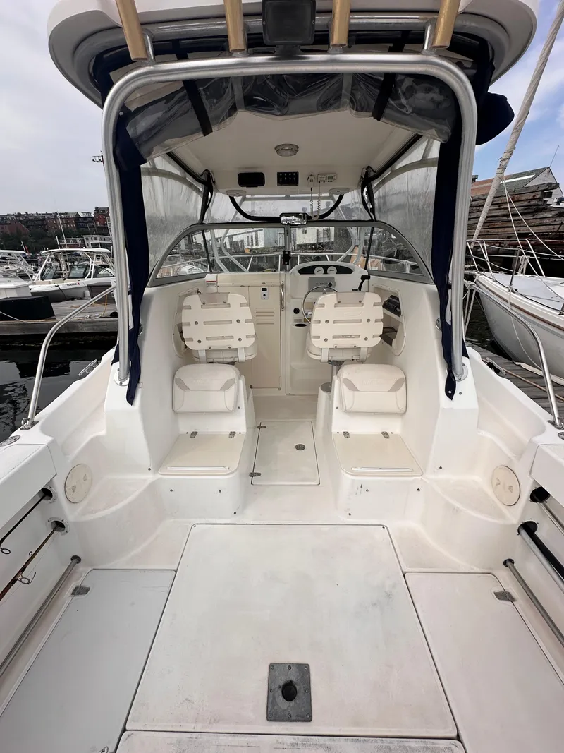 Slide: The Image of 2003 Boston Whaler 255 Conquest boat interior with dual seats and steering console. - 7