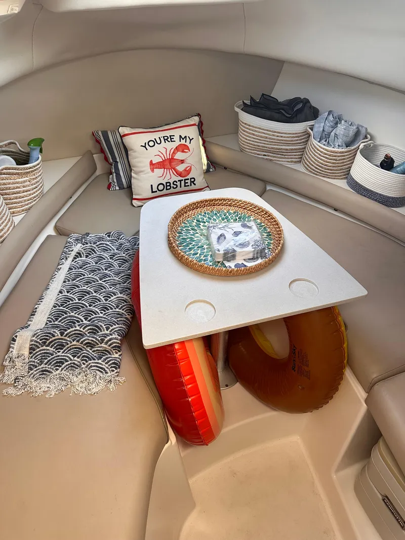 Slide: The Image of 2003 Boston Whaler 255 Conquest cabin interior with nautical decor and storage baskets. - 8