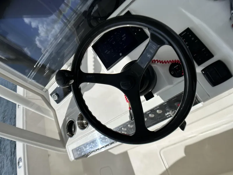 Slide: The Image of 2022 SeaVee 390z Center Console steering wheel and dashboard controls. - 11