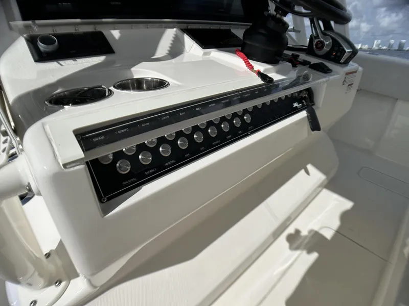 Slide: The Image of 2022 SeaVee 390z Center Console boat dashboard with control panel and cup holders. - 13
