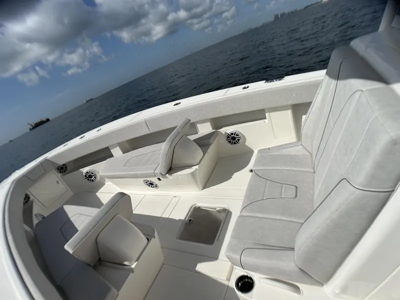 Slide: The Image of 2022 SeaVee 390z Center Console boat interior with cushioned seating and ocean view. - 15