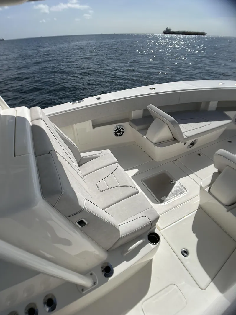 Slide: The Image of 2022 SeaVee 390z Center Console boat interior with cushioned seating on open water. - 17