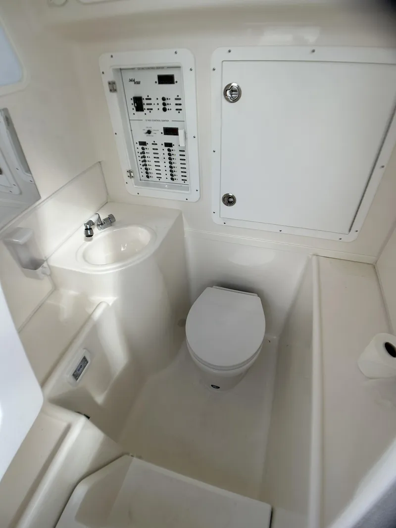 Slide: The Image of 2022 SeaVee 390z Center Console boat interior bathroom with sink and toilet. - 19