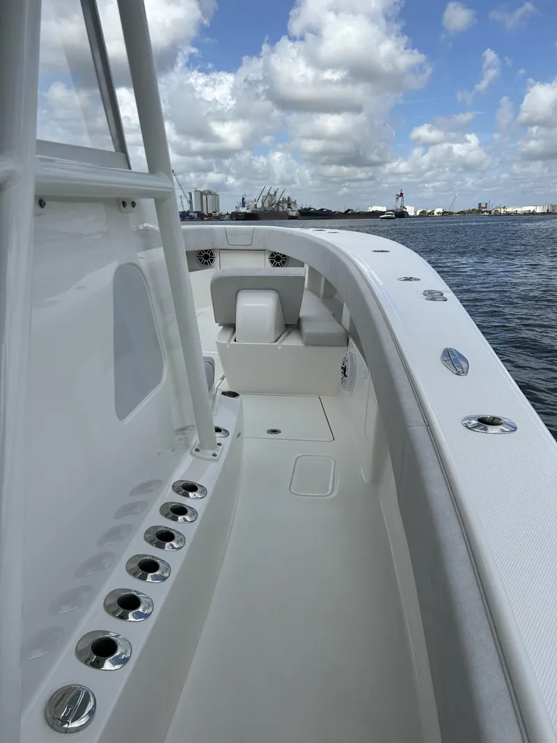 Slide: The Image of 2022 SeaVee 390z Center Console boat on calm waters under a partly cloudy sky. - 20