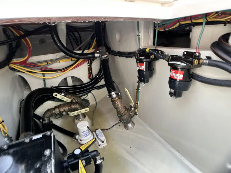 Slide: The Image of 2022 SeaVee 390z Center Console engine compartment with wiring and fuel filters. - 23