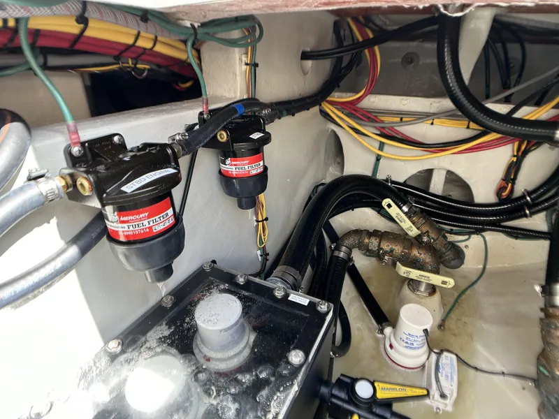Slide: The Image of 2022 SeaVee 390z Center Console engine compartment with fuel filters and wiring. - 24