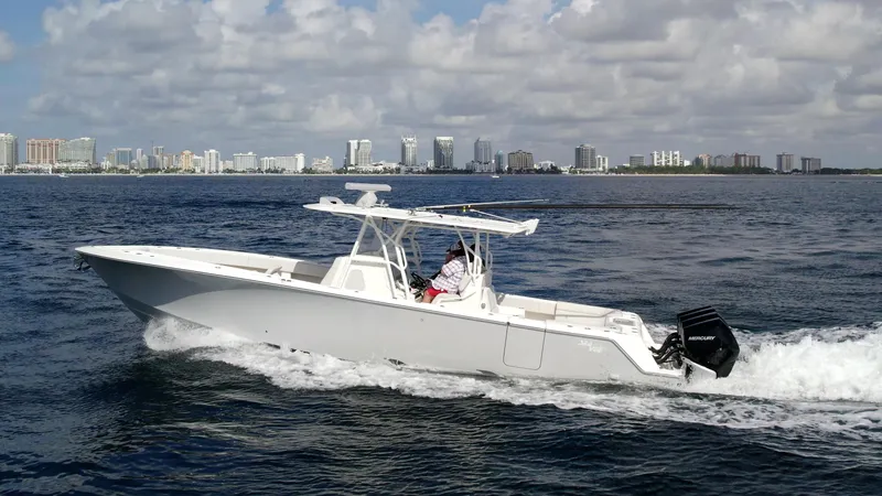 Slide: The Image of 2022 SeaVee 390z Center Console boat cruising on the ocean with city skyline in the background. - 5