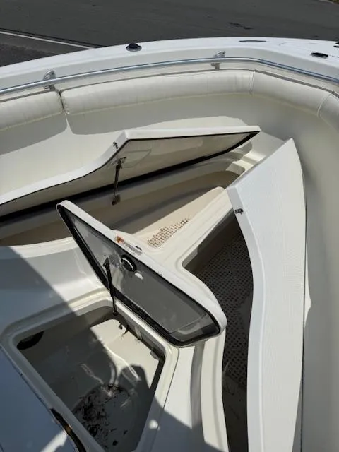 Slide: The Image of 2003 Hydra-Sports Vector 2400 CC boat with open storage compartments. - 11